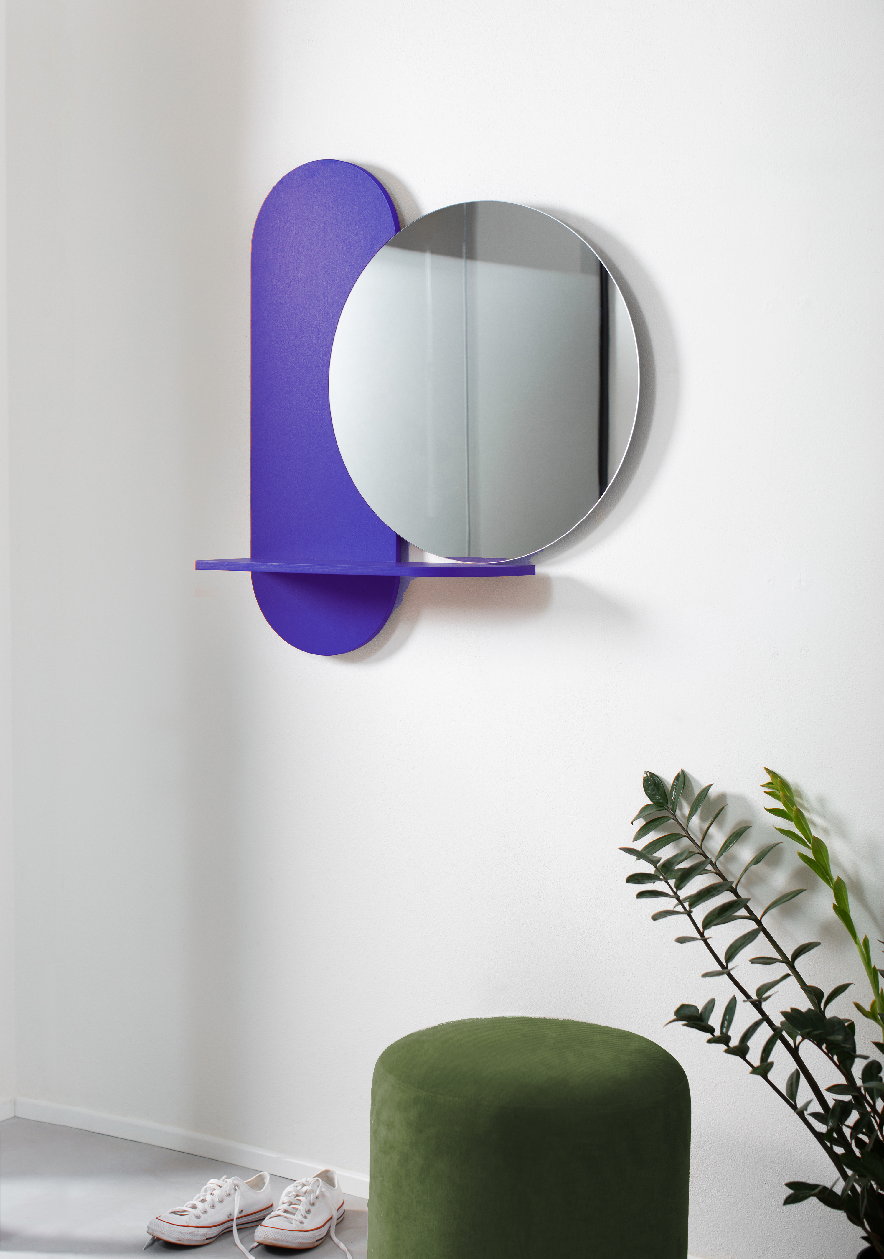 Round blue wall mirror in entryway
modern entry hall design